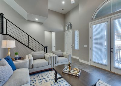 Modern living room with double doors and staircase
