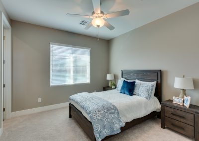 Modern bedroom with gray bed and blue accents