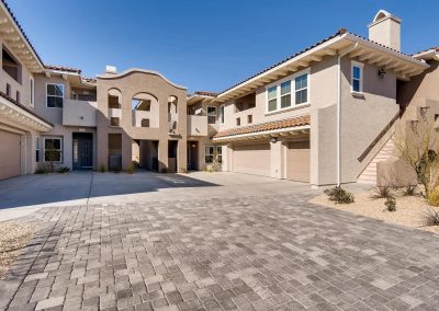 Stucco Mediterranean townhome courtyard with tiled roofs