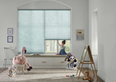 Child at window seat with plush toys