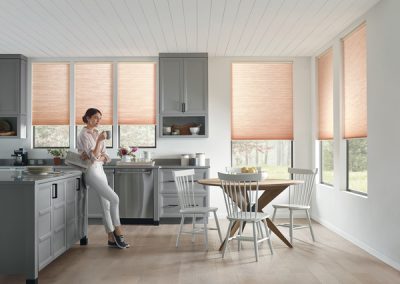 Woman sipping coffee in modern gray kitchen