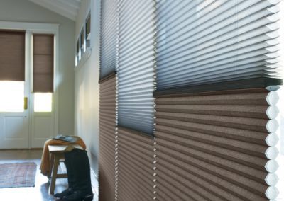 Two-tone cellular window shades in entryway
