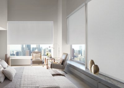 Minimalist bedroom with city-view roller shades