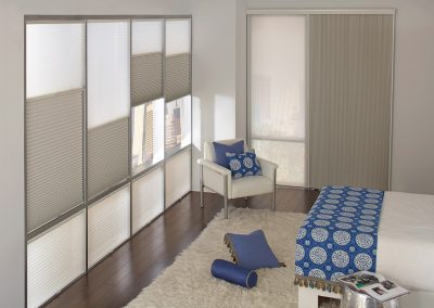 Bright bedroom with blue accents and window blinds