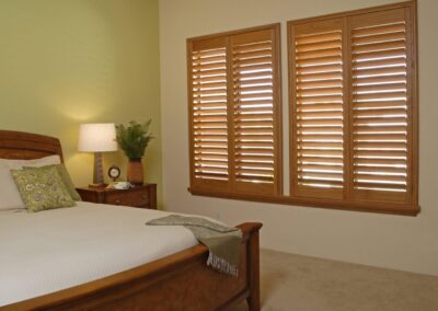 Cozy bedroom with wooden plantation shutters