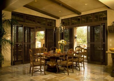 Sunlit dining room with wooden shutters