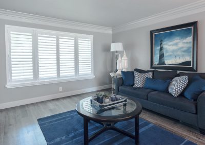 Cozy blue living room with lighthouse painting