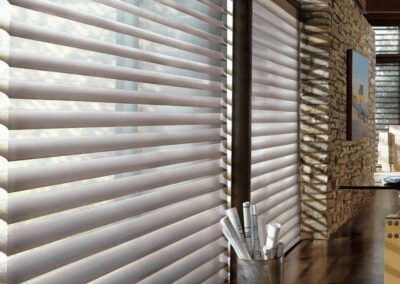 Sheer horizontal window shades with stone wall